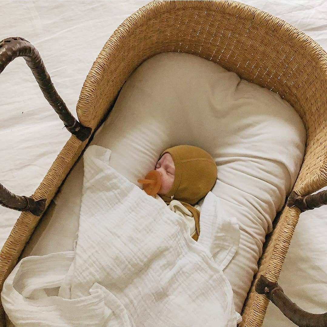 Newborn sleeping cheap in moses basket